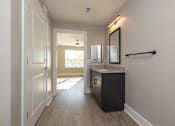 Thumbnail 12 of 23 - A bathroom with a sink, mirror, and a towel bar at Dunean Creek Apartments, South Carolina