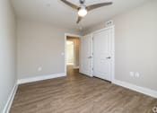 Thumbnail 17 of 23 - A room with a ceiling fan and two doors at Dunean Creek Apartments, South Carolina