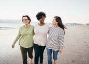 Thumbnail 9 of 16 - three women walking on the beach