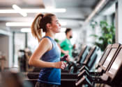 Thumbnail 8 of 16 - a woman running on a treadmill at a gym