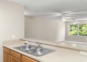 Thumbnail 2 of 6 - an empty kitchen with a sink and a window