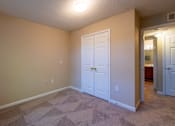 Thumbnail 6 of 11 - A room with a white door and carpeted floor at Lakeside Gardens Apartments, North Carolina, 27713