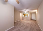 Thumbnail 2 of 11 - A room with a carpeted floor and a ceiling fan at Lakeside Gardens Apartments, Durham