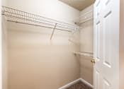 Thumbnail 7 of 11 - A white closet with a door and a shelf at Lakeside Gardens Apartments, Durham, North Carolina