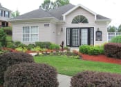 Thumbnail 4 of 13 - a home with a lawn and garden in front of it
