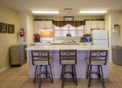 Thumbnail 18 of 28 - a kitchen with a large island with three chairs