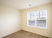 Thumbnail 5 of 28 - an empty bedroom with a large window and carpeted flooring