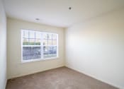 Thumbnail 7 of 28 - an empty room with a large window and carpeting