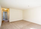 Thumbnail 4 of 28 - a spacious living room with carpet and white walls
