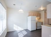 Thumbnail 6 of 28 - an empty kitchen with a refrigerator and a window