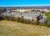 Thumbnail 28 of 28 - an aerial view of a large building in the middle of a field