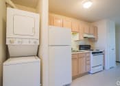Thumbnail 11 of 28 - a kitchen with white appliances and wooden cabinets