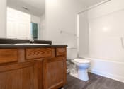Thumbnail 15 of 21 - an empty bathroom with a toilet and a sink at Pendleton Townhomes Apartments, Durham