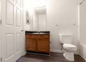 Thumbnail 20 of 21 - a bathroom with a toilet and a sink and a mirror at Pendleton Townhomes Apartments, Durham