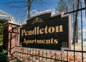 Thumbnail 2 of 21 - a sign in front of a fence at Pendleton Townhomes Apartments, Durham, North Carolina
