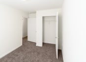 Thumbnail 21 of 21 - an empty bedroom with white walls and carpet and a closet at Pendleton Townhomes Apartments, North Carolina 27703