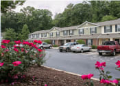 Thumbnail 1 of 21 - a parking lot in front of a building at Pendleton Townhomes Apartments, Durham, 27703