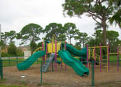 Thumbnail 5 of 7 - a playground with slides at a park