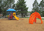 Thumbnail 8 of 13 - a playground with a swing set and a slide