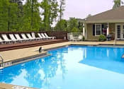 Thumbnail 1 of 15 - a large swimming pool in front of a clubhouse