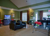 Thumbnail 9 of 19 - a living room with leather furniture and a television