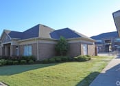 Thumbnail 5 of 19 - the front of a brick house with a yard and grass