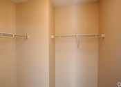 Thumbnail 16 of 19 - a empty closet in a bathroom with two empty shelves