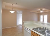 Thumbnail 14 of 19 - an empty kitchen with a sink and a counter top