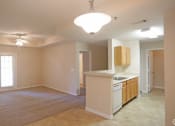 Thumbnail 11 of 19 - an empty kitchen and living room with a white counter top