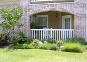 Thumbnail 12 of 15 - the front porch of a brick house with a white railing
