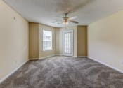 Thumbnail 15 of 15 - an empty living room with a ceiling fan