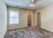 Thumbnail 10 of 15 - an empty living room with a ceiling fan and a window