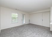 Thumbnail 9 of 26 - Empty room with white walls and carpet.