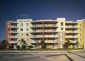 Thumbnail 6 of 7 - a rendering of an apartment building on the corner of a street