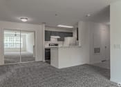 Thumbnail 1 of 17 - A kitchen area with a refrigerator, cabinets, and a window.