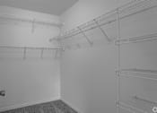 Thumbnail 7 of 17 - Empty room with shelves and a door.