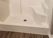 Thumbnail 7 of 21 - A white bathtub with a shower head and hand held shower.