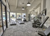 Thumbnail 6 of 17 - spacious fitness center with treadmills and other exercise equipment at Dwell at Greenridge, North Charleston, 29406