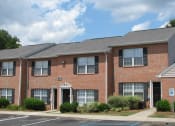 Thumbnail 11 of 13 - a brick apartment building with a sidewalk in front of it