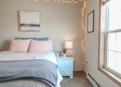 Thumbnail 24 of 32 - a bedroom with a bed and a night stand and a window at Boulder Ridge, Minnesota, 55811