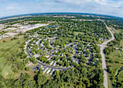 Thumbnail 12 of 16 - an aerial view of a city with a parking lot    and a highway
