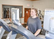 Thumbnail 10 of 32 - a woman walking on a treadmill in a gym at Boulder Ridge, Duluth, MN