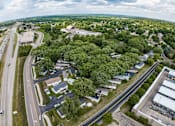 Thumbnail 10 of 16 - an aerial view of a city with trees and a highway