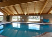 Thumbnail 14 of 32 - a swimming pool under a wooden ceiling in a hotel at Boulder Ridge, Duluth, 55811