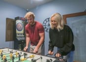 Thumbnail 26 of 32 - a man and a woman standing next to a foosball table at Boulder Ridge, Duluth, MN