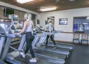 Thumbnail 23 of 32 - a woman walking on a treadmill in a gym at Boulder Ridge, Duluth Minnesota