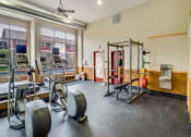 Thumbnail 7 of 27 - a gym with weights and equipment in a room with windows at Campus Park, Duluth, 55811