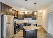 Thumbnail 24 of 35 - a kitchen with stainless steel appliances and wooden cabinets at Arbor Ridge, Forest Lake, MN, 55025