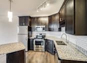 Thumbnail 14 of 35 - a kitchen with stainless steel appliances and granite counter tops at Arbor Ridge, Forest Lake, Minnesota