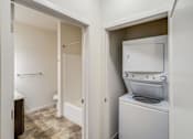 Thumbnail 34 of 35 - a washer and dryer in a laundry room with a door to a bathroom at Arbor Ridge, Forest Lake, 55025